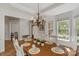 Bright dining room with an oval wooden table, chandelier, and hardwood floors at 3017 Chisholm Ct, Waxhaw, NC 28173