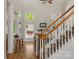 Bright foyer featuring a staircase with carpeted steps and a modern entry with bar and high ceilings at 3017 Chisholm Ct, Waxhaw, NC 28173