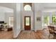 Bright foyer with hardwood floors, transom window and decorative front door at 3017 Chisholm Ct, Waxhaw, NC 28173