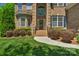 Inviting front entrance with brick facade, manicured bushes, and a well-maintained lawn at 3017 Chisholm Ct, Waxhaw, NC 28173
