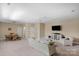 Spacious living room with comfortable seating, ceiling fan and an adjacent dining area, perfect for gatherings at 3017 Chisholm Ct, Waxhaw, NC 28173