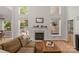 Bright living room with fireplace and wall of windows overlooking the outdoor area at 3017 Chisholm Ct, Waxhaw, NC 28173