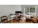 Bright office with a large window, hardwood floors, and a modern desk setup at 3017 Chisholm Ct, Waxhaw, NC 28173