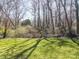 Lush backyard featuring mature trees and a well-maintained lawn at 306 7Th Street Ne Pl, Conover, NC 28613