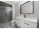 Modern bathroom with a black-framed shower, stylish vanity, and a large mirror at 306 7Th Street Ne Pl, Conover, NC 28613