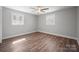 Bright bedroom with ceiling fan, hardwood floors, and large windows offering natural light at 306 7Th Street Ne Pl, Conover, NC 28613