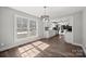 Open-concept dining room with large windows and seamless flow into the updated kitchen at 306 7Th Street Ne Pl, Conover, NC 28613
