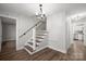 Entryway features a modern staircase with wooden treads and handrail, and updated lighting at 306 7Th Street Ne Pl, Conover, NC 28613