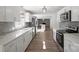 Bright kitchen featuring stainless steel appliances, white cabinetry, and stylish backsplash at 306 7Th Street Ne Pl, Conover, NC 28613