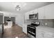 Spacious kitchen featuring updated appliances, white cabinets, and sleek countertops at 306 7Th Street Ne Pl, Conover, NC 28613