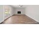 Spacious living room features hardwood floors, a brick fireplace, and access to the outdoors at 306 7Th Street Ne Pl, Conover, NC 28613