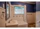 Quaint bathroom with blue accents, tiled walls, and a classic vanity at 312 Gold Hill Ave, Rockwell, NC 28138