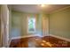 Bright bedroom featuring hardwood floors, a closet, and a large window with natural light at 312 Gold Hill Ave, Rockwell, NC 28138
