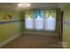 Bedroom features charming cartoon accent wall, window with decorative curtains, and neutral carpeting at 312 Gold Hill Ave, Rockwell, NC 28138