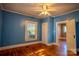 Bright bedroom with hardwood floors, natural light, and adjoining doorway to living area at 312 Gold Hill Ave, Rockwell, NC 28138