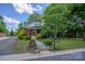 Charming two-story home with lush landscaping, sidewalk, and bright red door at 312 Gold Hill Ave, Rockwell, NC 28138
