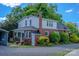 Charming two-story home with brick and vinyl siding, surrounded by lush landscaping and a stone walkway at 312 Gold Hill Ave, Rockwell, NC 28138