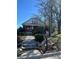Inviting front exterior featuring a classic red door, lush landscaping, and stone steps at 312 Gold Hill Ave, Rockwell, NC 28138