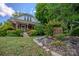 Charming home exterior with brick accents and a beautifully landscaped yard at 312 Gold Hill Ave, Rockwell, NC 28138