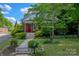 Inviting home exterior with a bright red door and manicured landscaping at 312 Gold Hill Ave, Rockwell, NC 28138