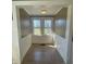 Bright sunroom with tiled flooring, wainscoting, and backyard views at 312 Gold Hill Ave, Rockwell, NC 28138