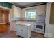 Charming kitchen with white cabinets, butcher block island, and view to the living room at 312 Gold Hill Ave, Rockwell, NC 28138