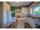 Cozy kitchen with white appliances, open layout, and view to the living space at 312 Gold Hill Ave, Rockwell, NC 28138