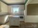 Well-lit kitchen with white cabinetry, tile flooring, and a functional island for meal preparation at 312 Gold Hill Ave, Rockwell, NC 28138