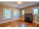 Cozy living room featuring hardwood floors and a classic fireplace at 312 Gold Hill Ave, Rockwell, NC 28138