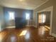 Spacious living room with hardwood floors, fireplace, and an open doorway, creating an inviting space at 312 Gold Hill Ave, Rockwell, NC 28138