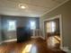 Bright living room with hardwood floors, fireplace, and natural light from multiple windows at 312 Gold Hill Ave, Rockwell, NC 28138