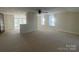 Living area with large windows, neutral carpet, and brick half wall at 312 Gold Hill Ave, Rockwell, NC 28138