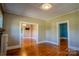 Spacious living room with gleaming hardwood floors and neutral wall color at 312 Gold Hill Ave, Rockwell, NC 28138