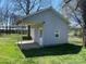Side view of outbuilding featuring a porch with a swing and a white entry door at 312 Gold Hill Ave, Rockwell, NC 28138
