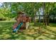 Backyard playground featuring a slide, climbing wall, and swings for outdoor fun at 312 Gold Hill Ave, Rockwell, NC 28138