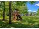 Backyard playground featuring a slide, climbing wall, and swings for outdoor fun at 312 Gold Hill Ave, Rockwell, NC 28138