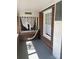 Enclosed porch with brick walls and windows with translucent white curtains at 312 Gold Hill Ave, Rockwell, NC 28138