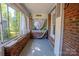 Sun room featuring brick walls and lots of windows at 312 Gold Hill Ave, Rockwell, NC 28138