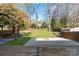 Expansive backyard with a wooden deck, manicured lawn, shed, and fire pit area at 3808 Severn Ave, Charlotte, NC 28210