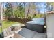 Backyard retreat featuring a hot tub, seating area, and landscaped yard, perfect for relaxation at 3808 Severn Ave, Charlotte, NC 28210