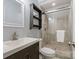 Modern bathroom with glass enclosed shower and dark wood vanity, offering a sleek design at 3808 Severn Ave, Charlotte, NC 28210