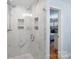 Modern bathroom showcasing a glass-enclosed shower, marble tile, and stylish design at 3808 Severn Ave, Charlotte, NC 28210