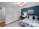 Bright bedroom featuring a desk, a patterned bedspread, and hardwood floors at 3808 Severn Ave, Charlotte, NC 28210