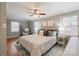 Comfortable bedroom featuring a ceiling fan, a patterned bedspread, and neutral decor for a relaxing atmosphere at 3808 Severn Ave, Charlotte, NC 28210