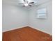 A bedroom that features a window with blinds and laminate flooring at 3808 Severn Ave, Charlotte, NC 28210