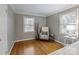 Bright bedroom showcasing a comfortable seating area, hardwood floors, and stylish decor at 3808 Severn Ave, Charlotte, NC 28210