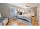 Cozy bedroom featuring two windows, a patterned bedspread, neutral decor and natural light at 3808 Severn Ave, Charlotte, NC 28210