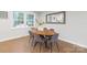 Elegant dining room with a modern oval table, seating for six, and natural light at 3808 Severn Ave, Charlotte, NC 28210