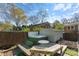 Outdoor hot tub with wooden deck and surrounding fence, perfect for relaxing and entertaining in backyard at 3808 Severn Ave, Charlotte, NC 28210