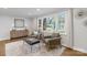 Cozy living room featuring neutral tones, comfortable seating, and large windows at 3808 Severn Ave, Charlotte, NC 28210